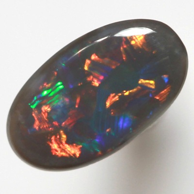 SOLID BLACK OPAL Flag Harlequin pattern. Sparkles of very bright fire red multicolour